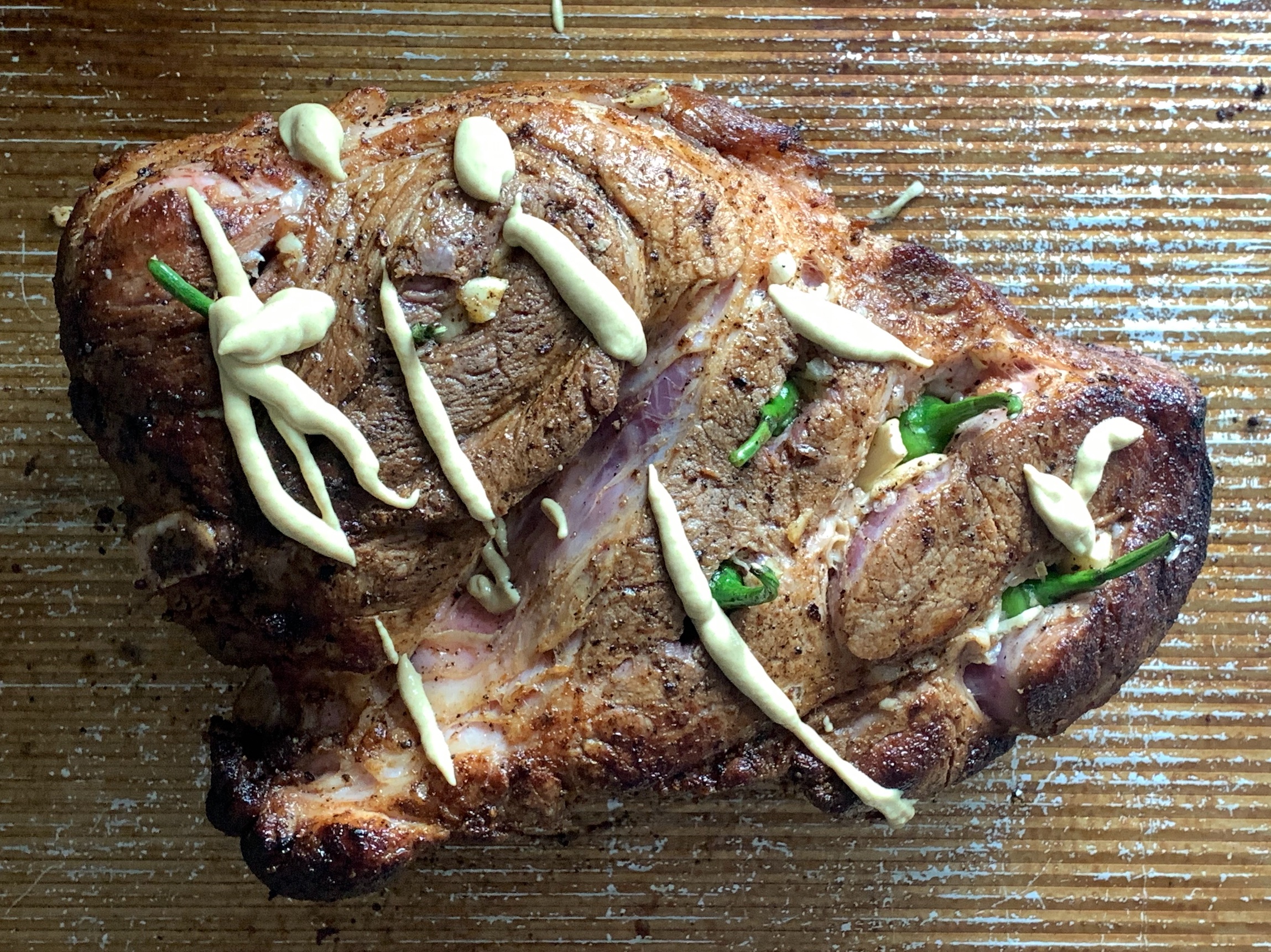 seared pork shoulder, slotted and stuffed with Serrano peppers, garlic, and covered in dijon mustard