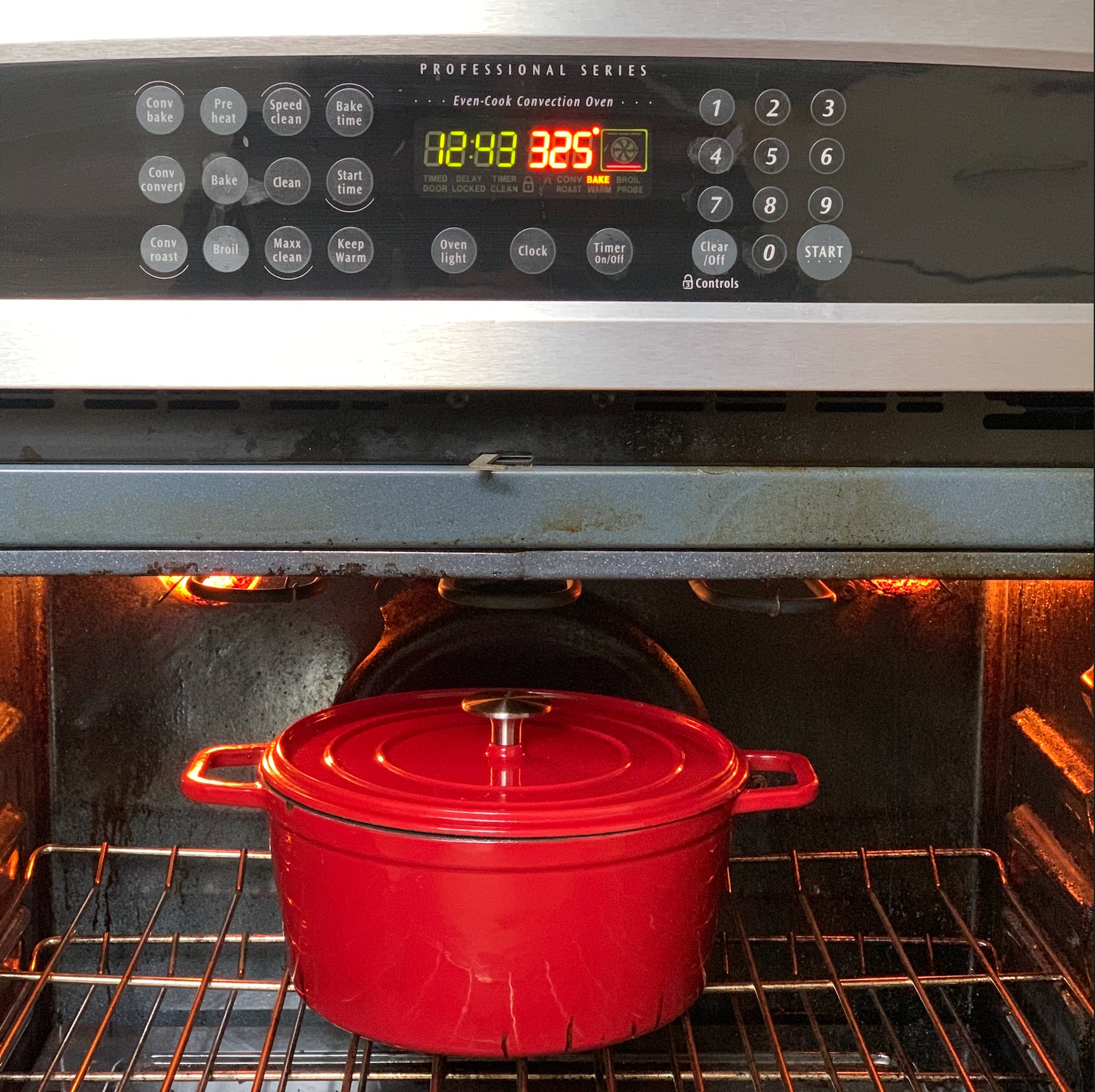 Covered dutch oven, loaded with prepared pork shoulder and braising liquids. It's inside an oven set at 325 for 3 hours